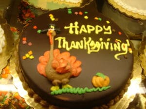 happy thanksgiving and a turkey in icing on a cake