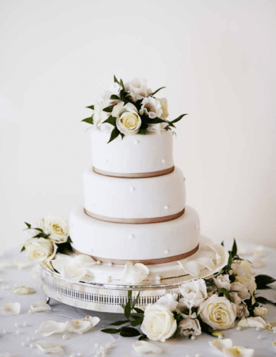 a white wedding cake with white flowers
