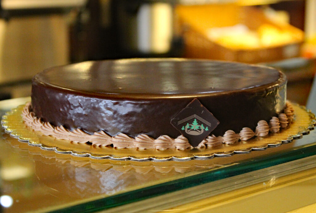 Dense Brownie-like cake with a thin layer of Chocolate Truffle Filling and topped with Chocolate Ganache